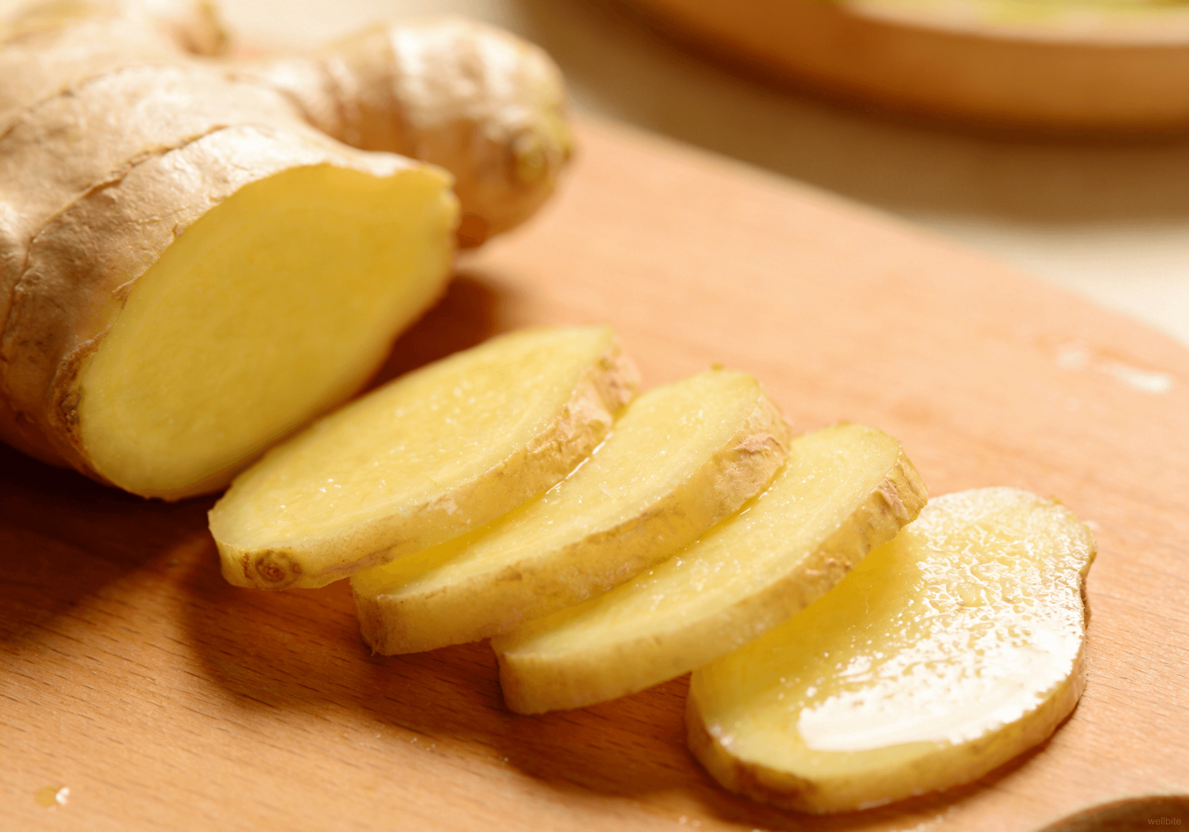 Fresh ginger being sliced thinly
